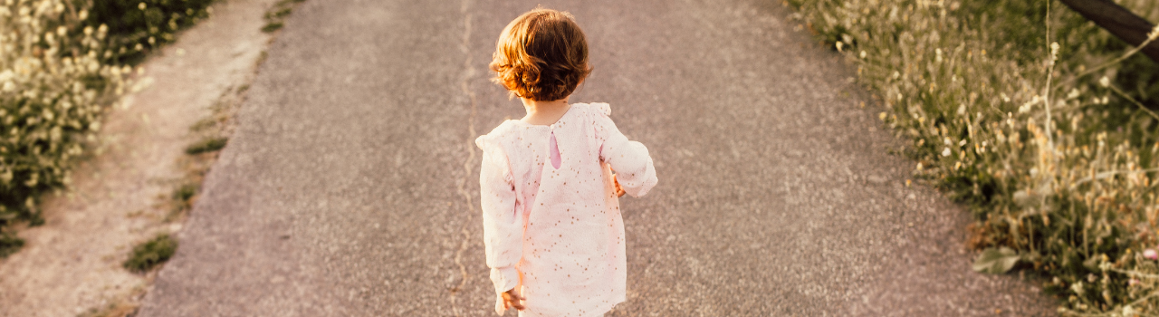 Young girl walking on road